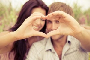 Couple making a heart.